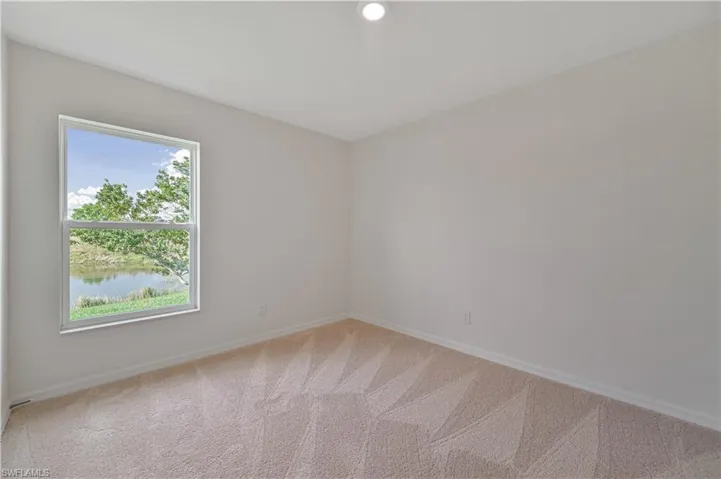 Empty room with plenty of natural light and carpet