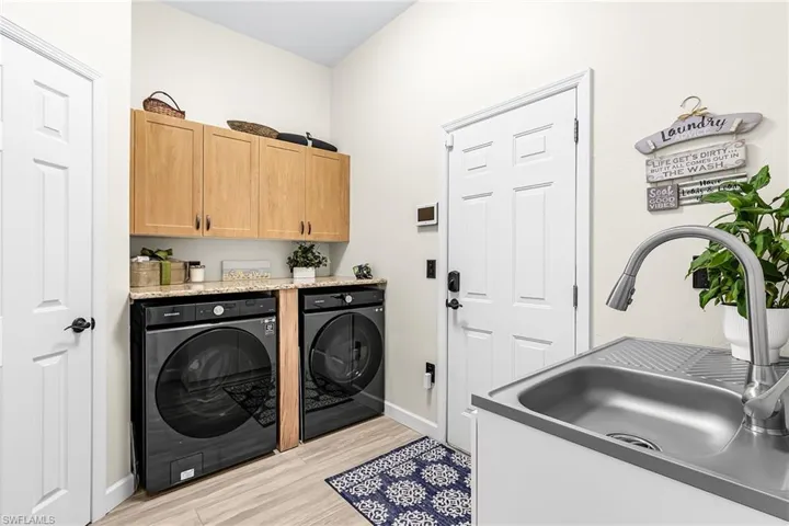 Well designed laundry room with storage closet and door leading to the garage.  (Washer & Dryer do not convey)