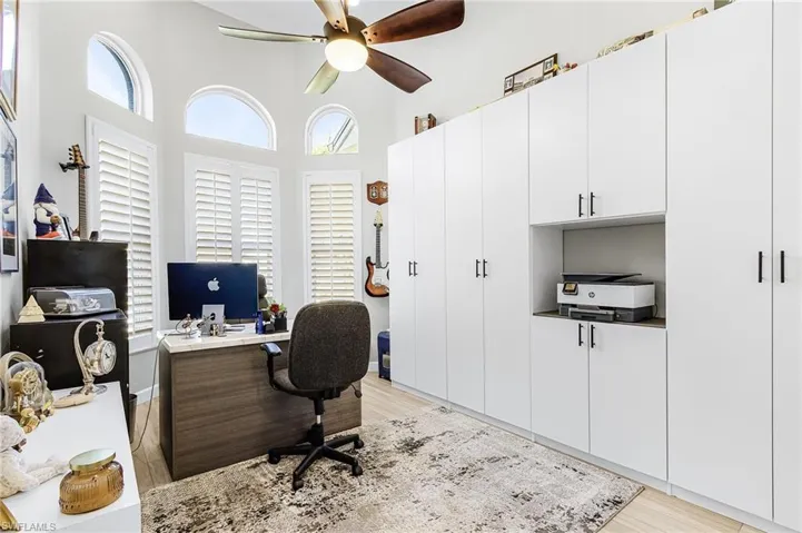 Very well organized space with continuation of flooring and great storage.  Bay windows with plantation shutters really set of this space for a relaxing office setting.