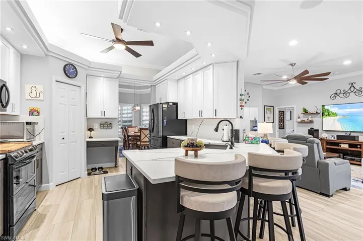 Solid surface counters, chic upgrades on stainless appliances, clean and well organized.