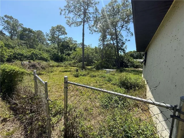 Left view of yard featuring fence
