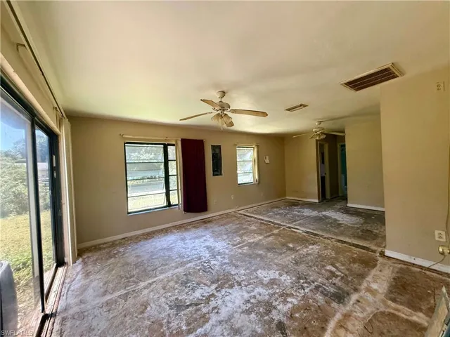 Great room featuring visible vents, baseboards, and ceiling fan