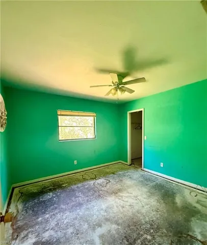 Bedroom with a ceiling fan and baseboards