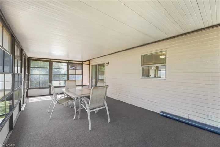 Unfurnished sunroom featuring wooden ceiling