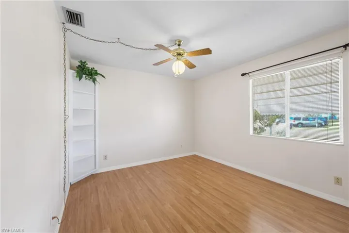 Spare room with ceiling fan and light wood-type flooring