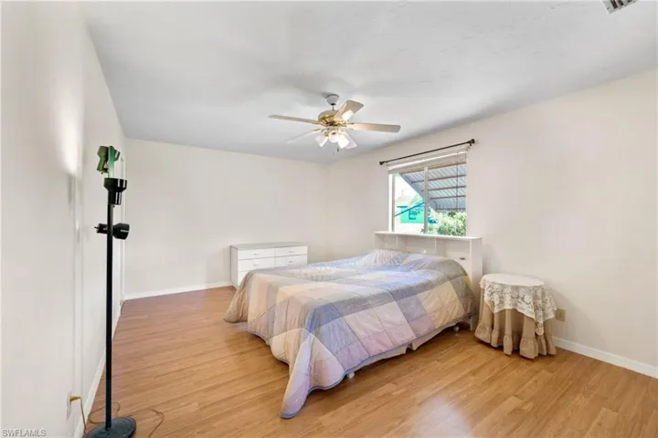 Bedroom with ceiling fan and light hardwood / wood-style flooring