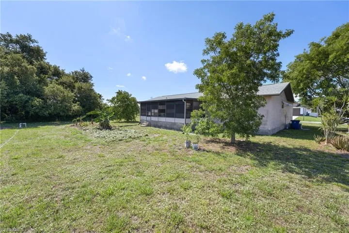 View of yard with a sunroom