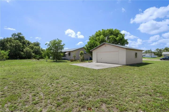 View of yard with a garage and an outdoor structure