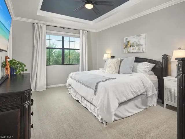 The primary bedroom features plenty of space and a lovely lake view.
