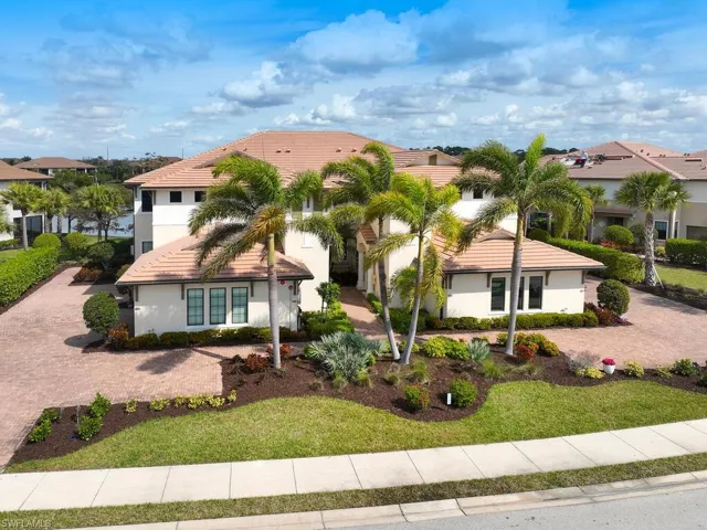 Elegant clubhouse with lush landscaping and resort-style amenities.