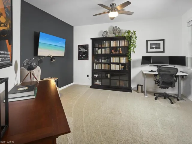 The large den features plenty of space to get your work done, and the black accent wall adds a touch of contemporary style.