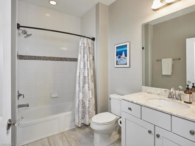 The guest bathroom features a desirable tub and shower combination, with floor to ceiling tile.