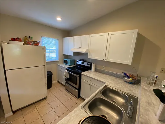 Kitchen from living room view. Includes a window.