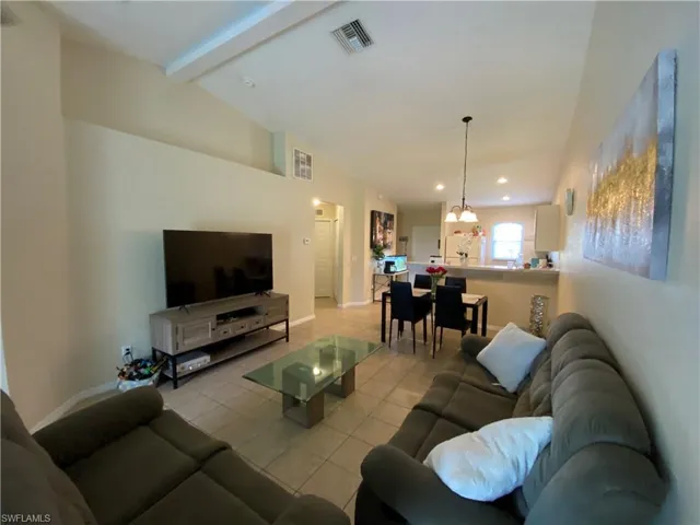 Tiled living room with very high ceilings.