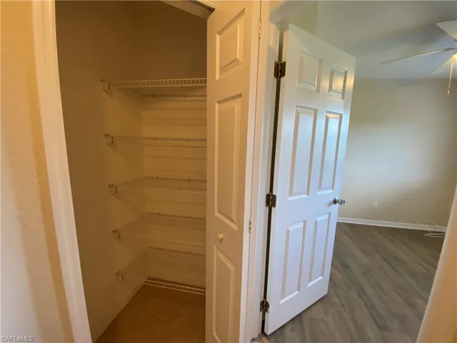 View of walk in linen closet that could also double as a pantry.