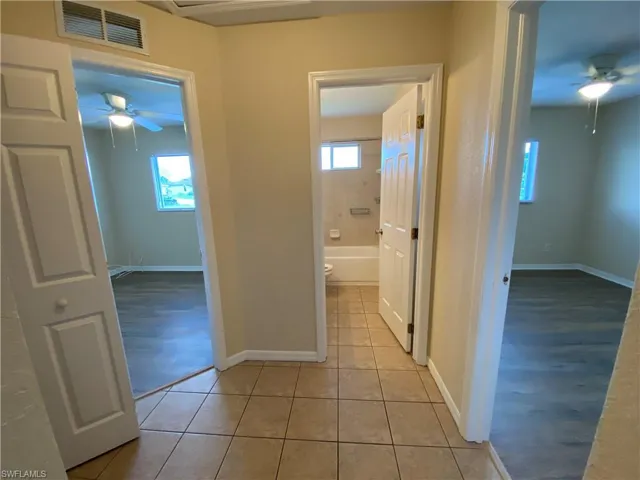 Hallway connecting bedrooms 1, 2, guest bathroom and big linen closet.