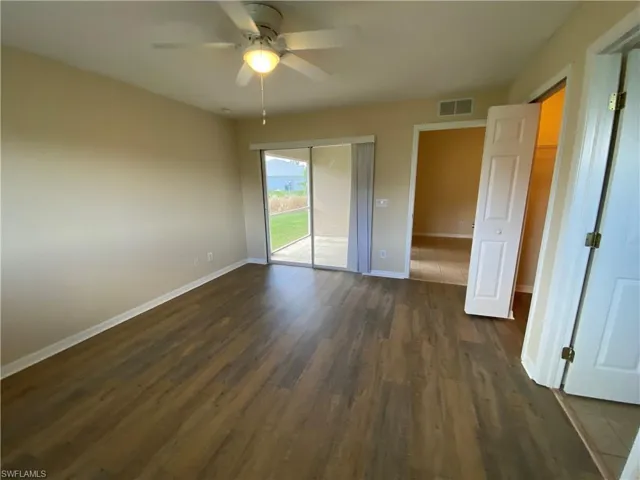 Master bedroom has a sliding glass door entrance to screened in lanai.