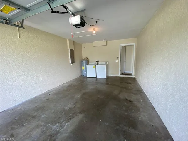 Garage featuring a electric garage door opener. Washer and Dryer hookup in garage. Water heater as well.