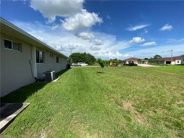 View of backyard featuring central AC.