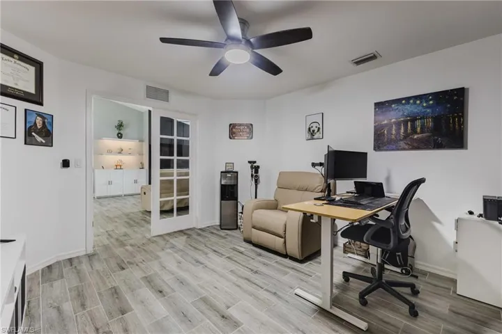 Office with wood tiled floors and ceiling fan