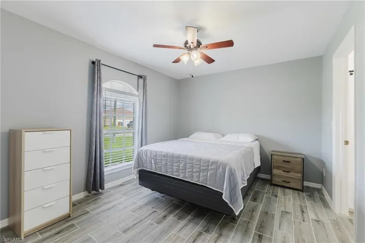 Bedroom featuring a ceiling fan and wood finish floors