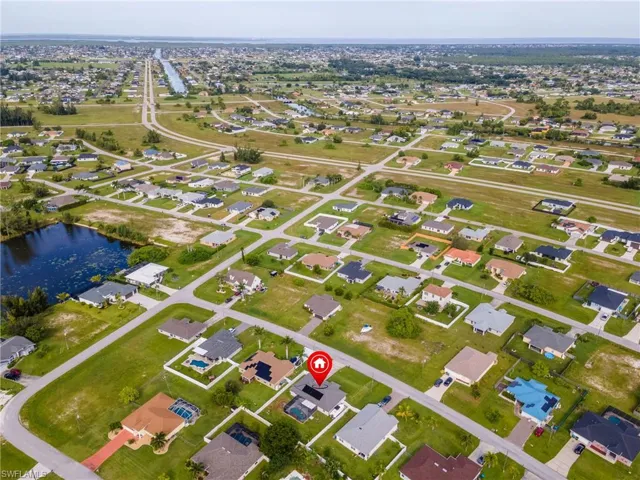 Aerial view of property's location with nearby suburban area and a large body of water