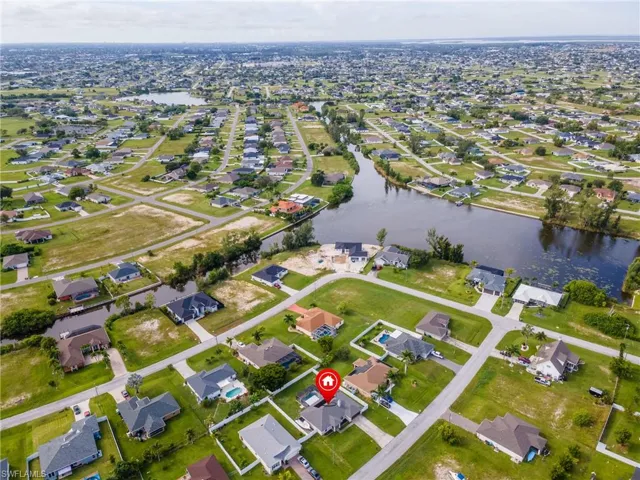 Aerial view of property's location with nearby suburban area