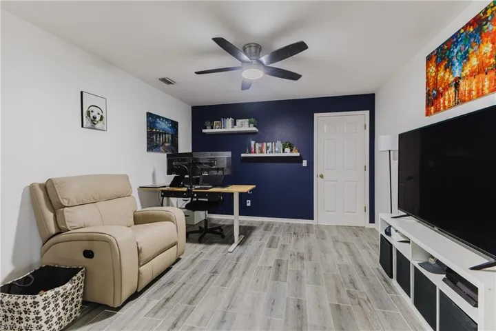 Office area featuring wood finish floors and a ceiling fan