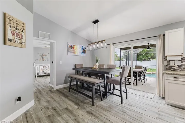 Dining space with lofted ceiling and light wood finished floors