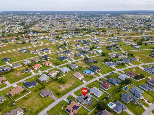 Aerial view of property's location featuring nearby suburban area