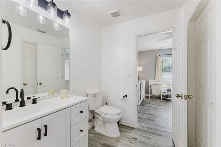 Bathroom with vanity and wood finish floors