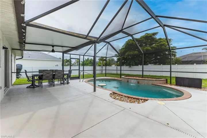 View of swimming pool featuring a patio area, glass enclosure, a sunroom, and a fenced backyard