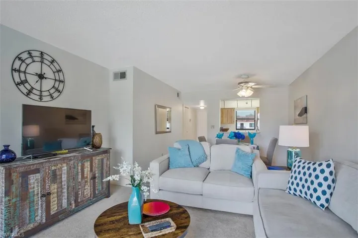 Great room featuring carpet and ceiling fan