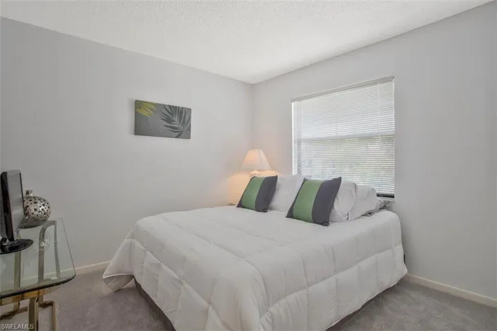 Carpeted guest  bedroom with its own full bath steps away