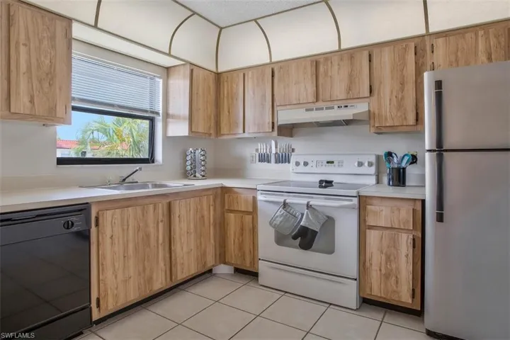 Kitchen featuring light tile floors