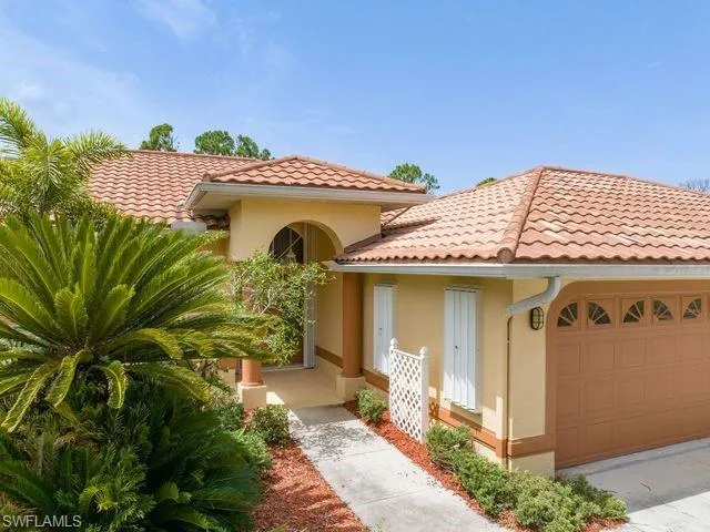 Mediterranean / spanish home with a garage