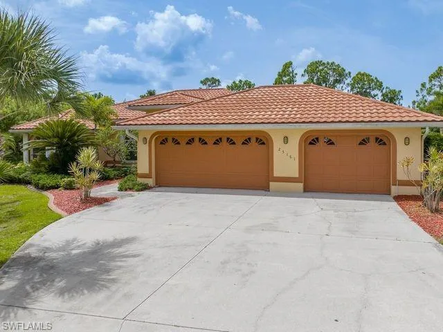 Mediterranean / spanish-style house with a garage