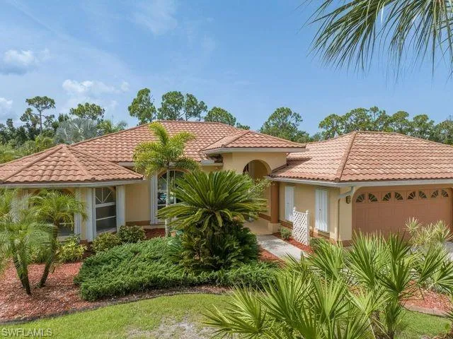 Mediterranean / spanish-style house with a garage