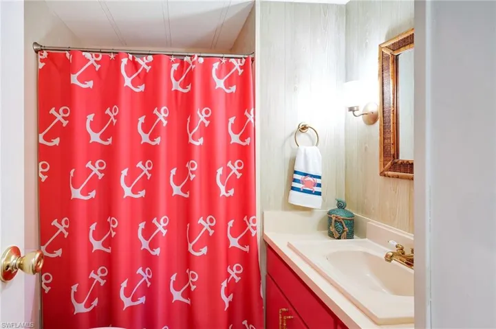 Bathroom featuring curtained shower and vanity