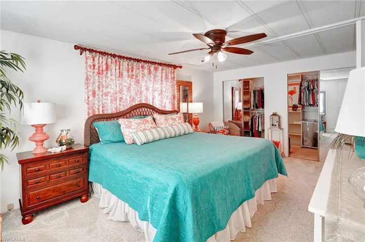 Carpeted bedroom with ceiling fan