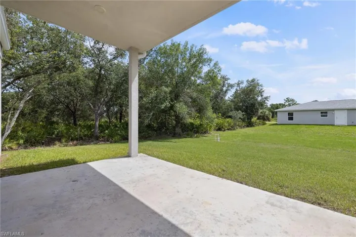 View of patio featuring view of wooded area