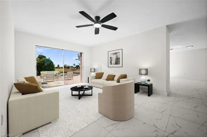 Living area with light marble finish floors and a ceiling fan