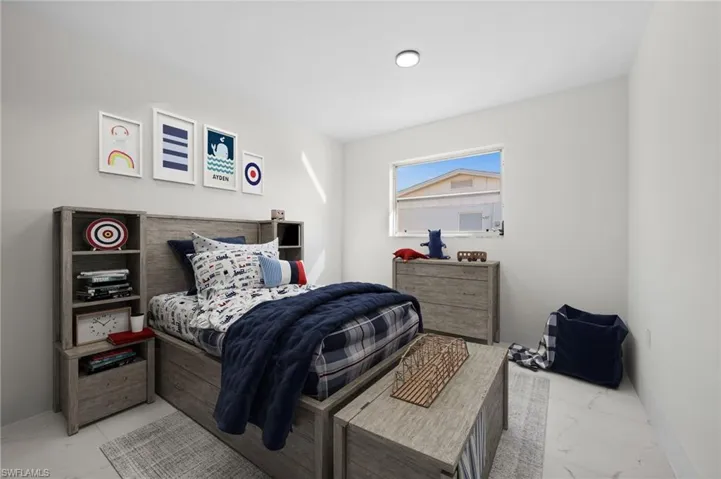 Bedroom with light marble finish floors and baseboards