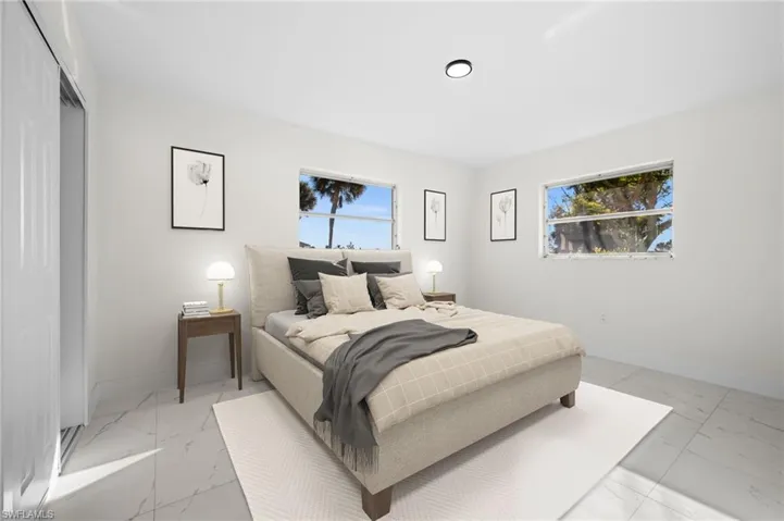 Bedroom with light marble finish flooring and baseboards
