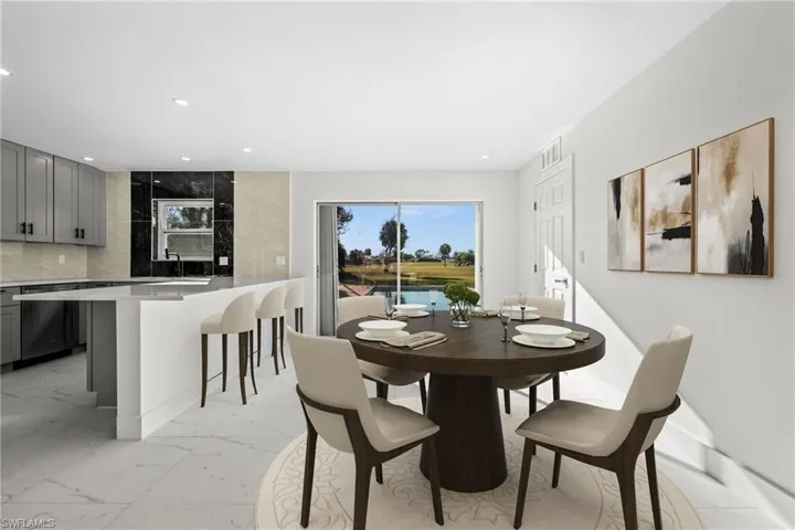 Dining room featuring light marble finish flooring and recessed lighting