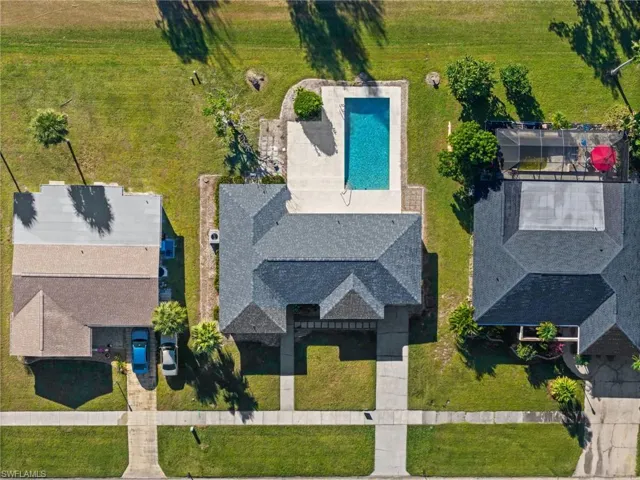 Drone / aerial view of a pool and a pastoral area