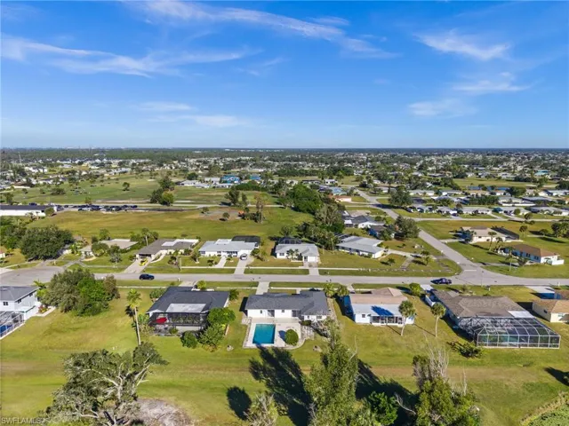 Aerial view of property's location with nearby suburban area