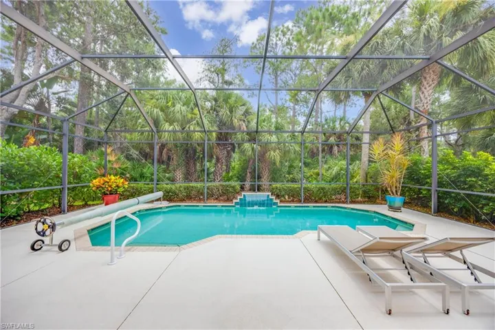 View of swimming pool with a patio area and a lanai