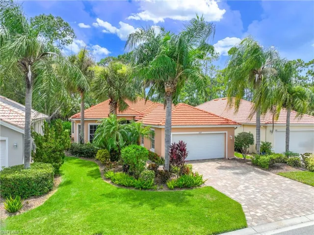 Heavenly home featuring a front yard and a garage