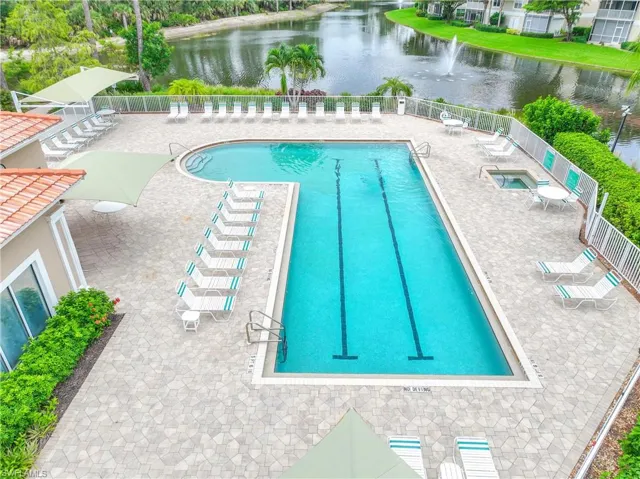 View of pool with a patio and a water view